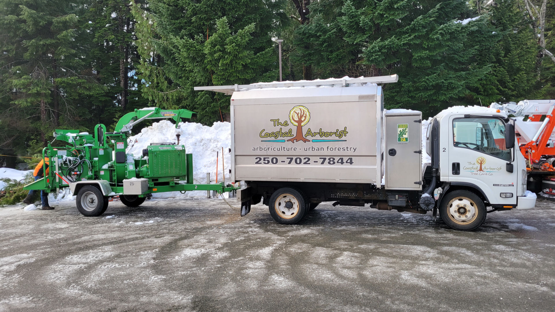Box Truck and chipper parked in a snowy parking lot in Campbell River